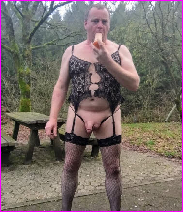 Sissy slut Jeffrey David Mitchell sucks a dildo while dressed in black lingerie