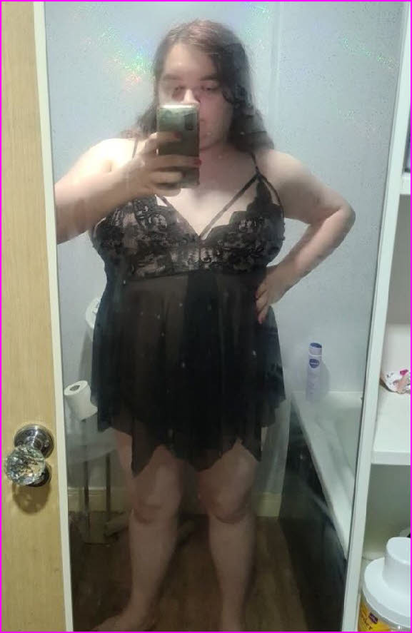 Effeminate sissy Flora mincing around in a black babydoll nightie