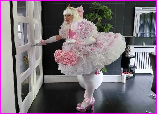 Total masculine failure Catrin wearing a stupidly frilly pink frock