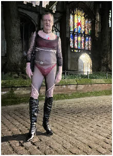 Male cross-dresser Jeffrey mincing around near a church in lingerie