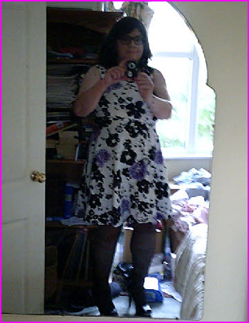 Sissy maid Janey's miniskirt fails to cover his stocking tops when he bends over